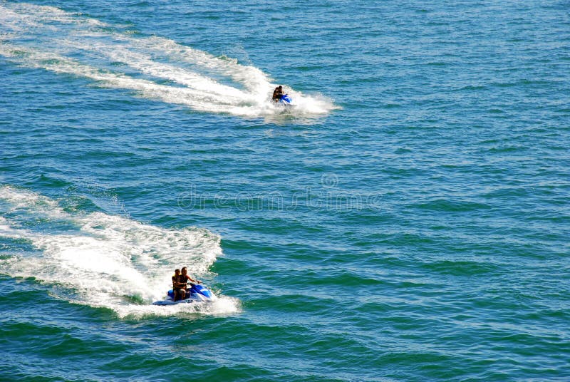 2 couples participating in a jet-ski race. 2 couples participating in a jet-ski race