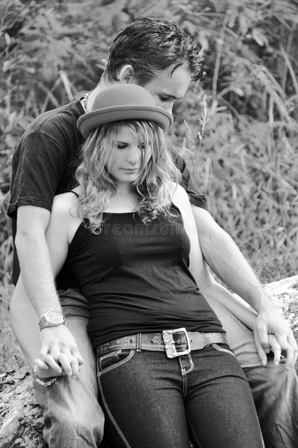 An intimate portrait of two young teenage lovers embracing each other and holding each others hands. Photograph done in black and white and taken in the bushlands of Queensland, Australia. An intimate portrait of two young teenage lovers embracing each other and holding each others hands. Photograph done in black and white and taken in the bushlands of Queensland, Australia.