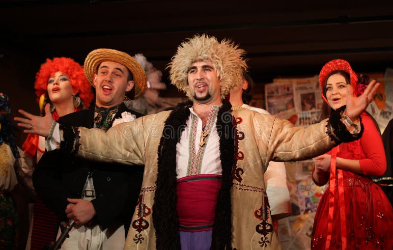 CHERNIVTSI, UKRAINE - NOVEMBER 11: Anastasia Skireiko, Pavlo Kantemir, Inna Moldovan performs Ukrainian folk show '' Patriot Lis Mikita '' at Golos theater in November 11, 2011, Chernivtsi, Ukraine. CHERNIVTSI, UKRAINE - NOVEMBER 11: Anastasia Skireiko, Pavlo Kantemir, Inna Moldovan performs Ukrainian folk show '' Patriot Lis Mikita '' at Golos theater in November 11, 2011, Chernivtsi, Ukraine