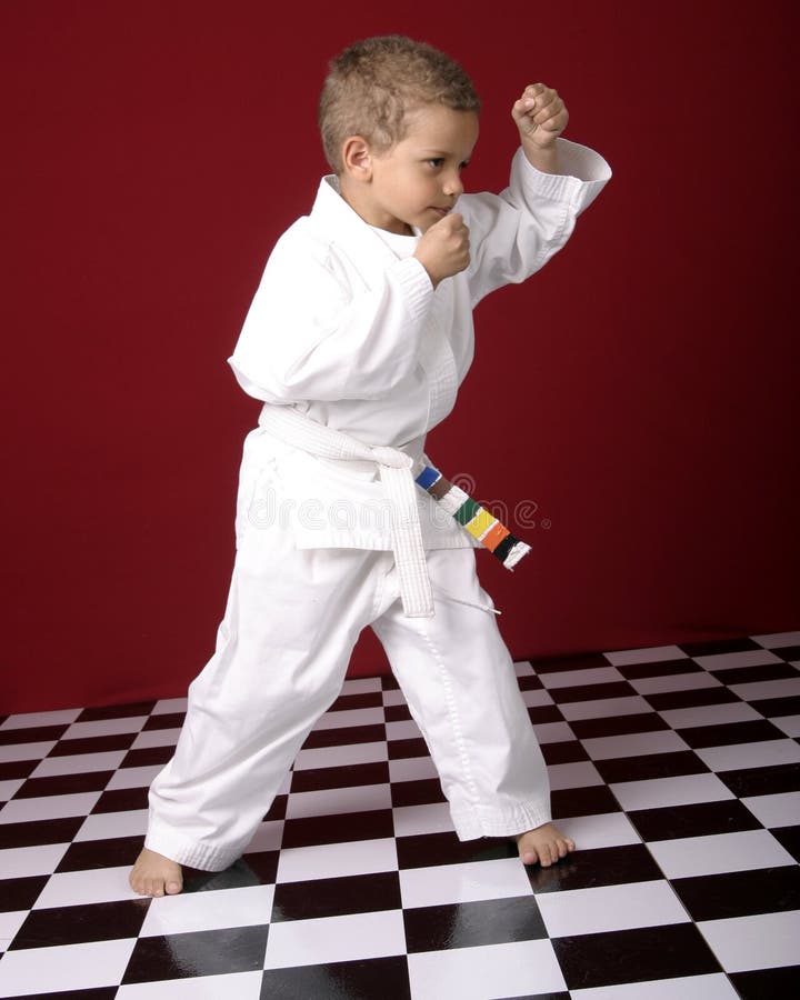 Young boy in karate uniform or gei performing martial arts moves. Young boy in karate uniform or gei performing martial arts moves