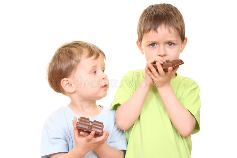 Five and three years old boys with chocolate isolated on white. Five and three years old boys with chocolate isolated on white