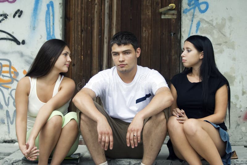 Two girls try to calm their friend. Two girls try to calm their friend.