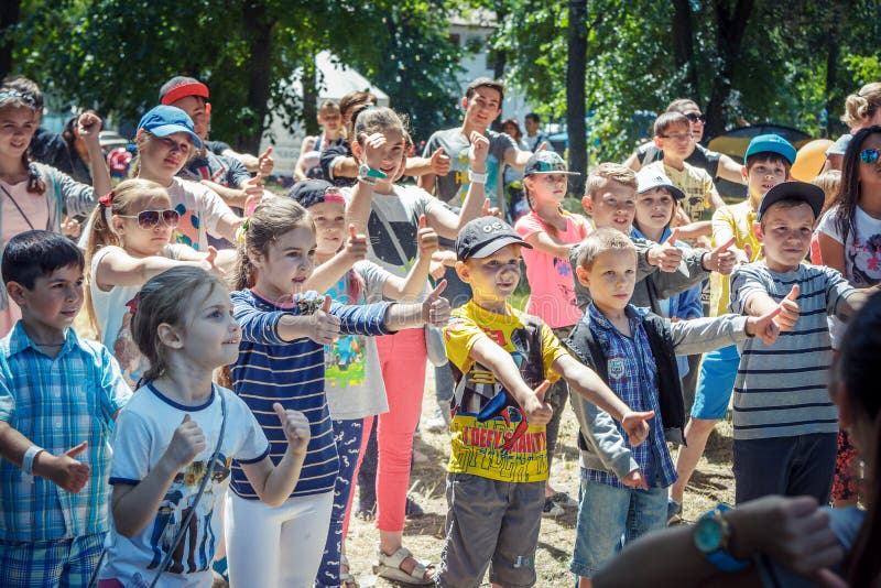 Zaporizhia/Ukraine- June 2, 2018: children – boys and girls participating at dancing activity on family charity festival in a city park. Outdoors entertainment for kids. Zaporizhia/Ukraine- June 2, 2018: children – boys and girls participating at dancing activity on family charity festival in a city park. Outdoors entertainment for kids.