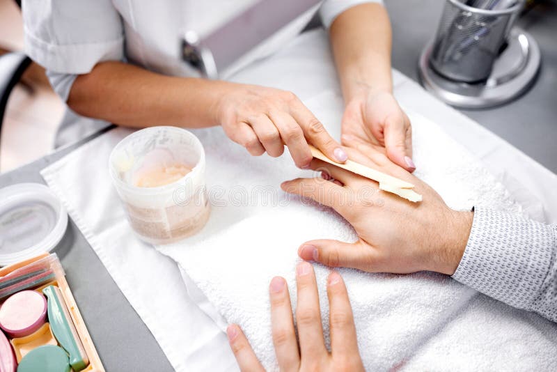 Manicures as a part of everyone’s regular grooming routine, man hands treatment, men manicure. Manicures as a part of everyone’s regular grooming routine, man hands treatment, men manicure