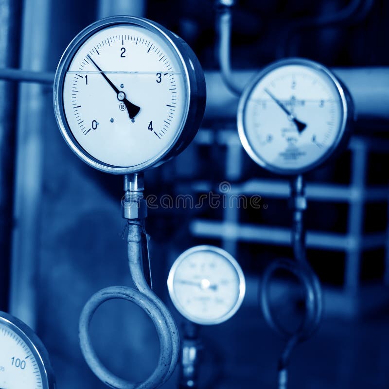 Closeup of manometer, pipes and faucet valves of heating system in a boiler room. Closeup of manometer, pipes and faucet valves of heating system in a boiler room