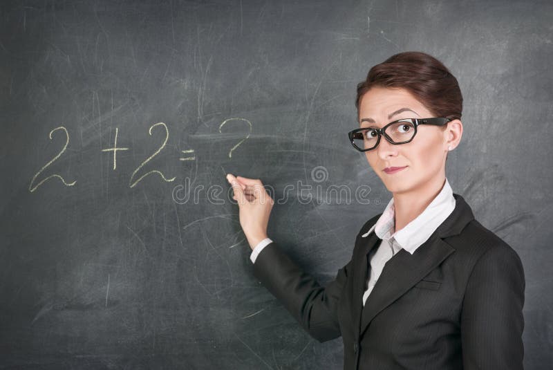 Woman teacher in glasses teaching maths. Woman teacher in glasses teaching maths