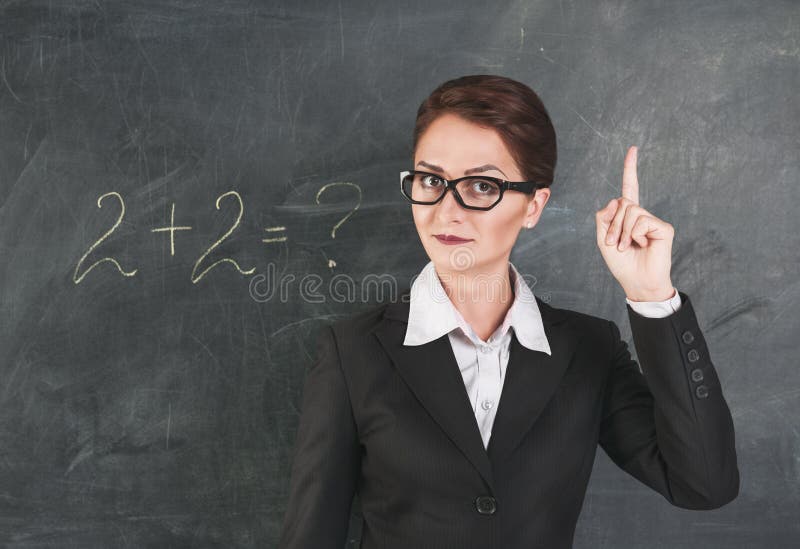 Woman teacher in glasses teaching maths and showing finger. Woman teacher in glasses teaching maths and showing finger