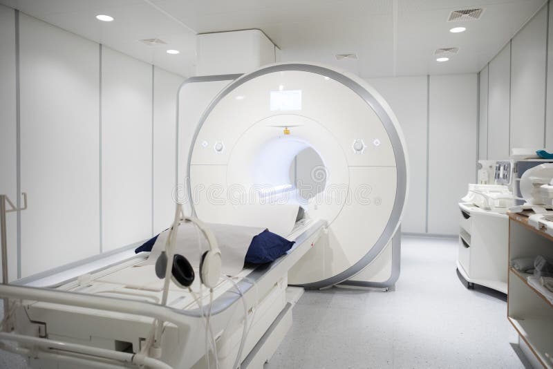 White MRI machine in empty illuminated hospital room. White MRI machine in empty illuminated hospital room