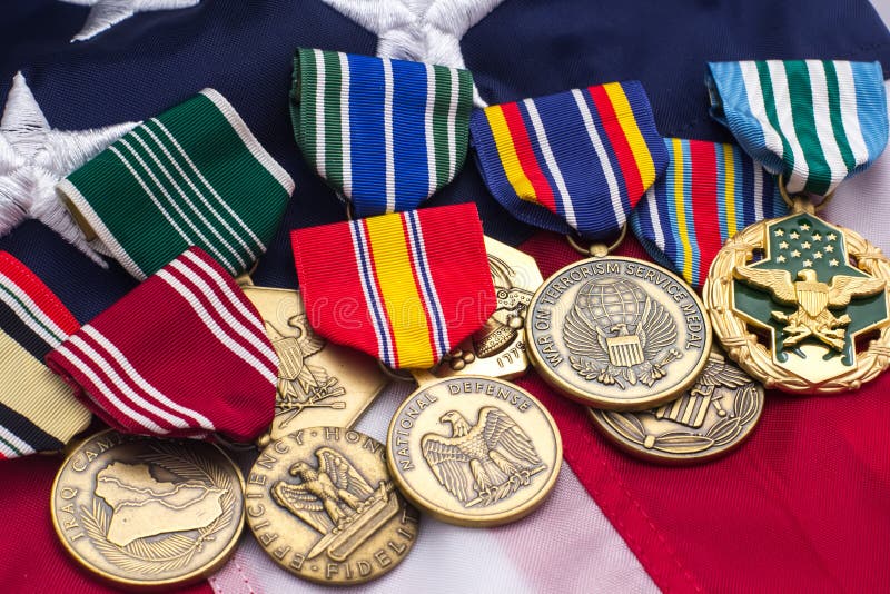 US Flag military medals laid on top. US Flag military medals laid on top.