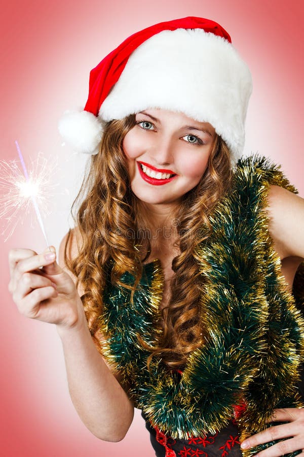 милые sparklers santa удерживания шлема девушки стоковая фотография rf милые sparklers santa удерживания шлема девушки стоковая фотография rf
