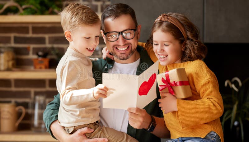 We love you, dad. Young happy father getting congratulations on Fathers Day from two excited kids at home, son and daughter, smiling children giving daddy handmade postcard and wrapped gift box. We love you, dad. Young happy father getting congratulations on Fathers Day from two excited kids at home, son and daughter, smiling children giving daddy handmade postcard and wrapped gift box