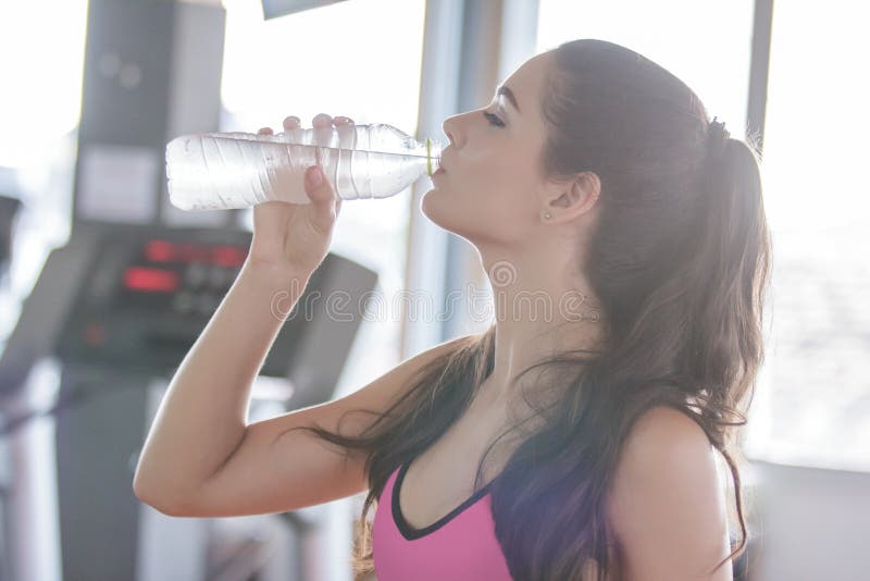 Минеральная вода Sporty женщины выпивая стоковая фотография Минеральная вода Sporty женщины выпивая стоковая фотография