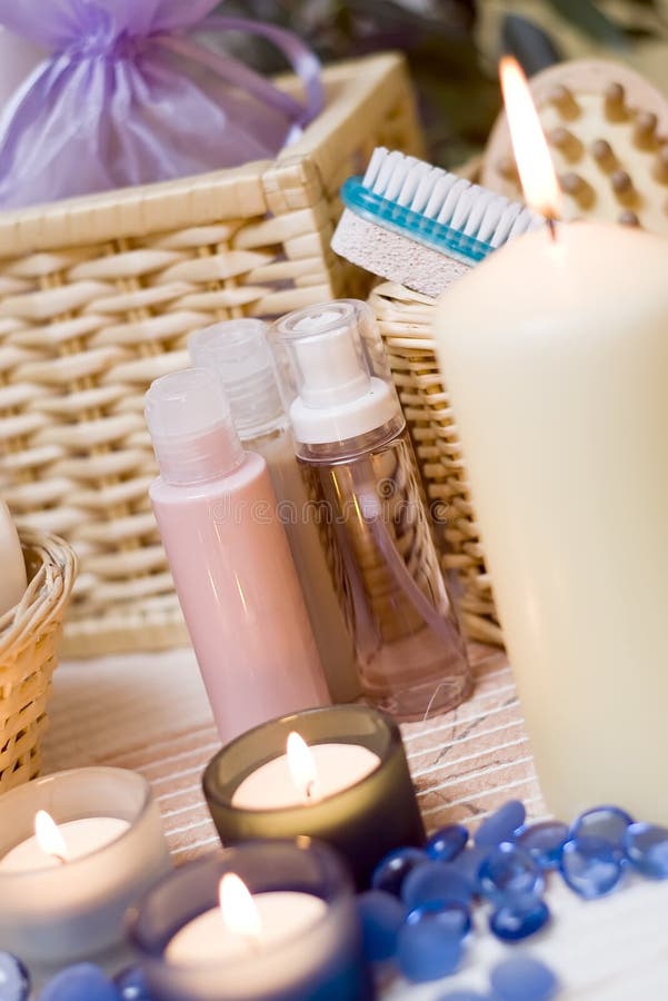 A spa composition with lit candles, a cosmetic bottles. A spa composition with lit candles, a cosmetic bottles.