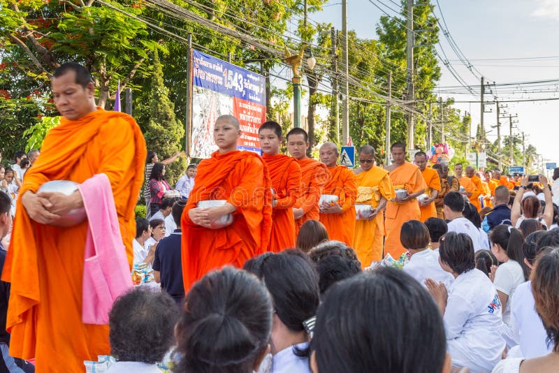 CHIANG MAI, THAILAND - May 31 : Many people give food and drink for alms to 1,536 Buddhist monks in visakha bucha day on May 31, 2015 in Chiang Mai, Thailand. CHIANG MAI, THAILAND - May 31 : Many people give food and drink for alms to 1,536 Buddhist monks in visakha bucha day on May 31, 2015 in Chiang Mai, Thailand.