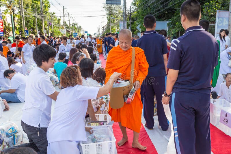 CHIANG MAI, THAILAND - May 31 : Many people give food and drink for alms to 1,536 Buddhist monks in visakha bucha day on May 31, 2015 in Chiang Mai, Thailand. CHIANG MAI, THAILAND - May 31 : Many people give food and drink for alms to 1,536 Buddhist monks in visakha bucha day on May 31, 2015 in Chiang Mai, Thailand.