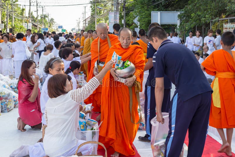CHIANG MAI, THAILAND - May 31 : Many people give food and drink for alms to 1,536 Buddhist monks in visakha bucha day on May 31, 2015 in Chiang Mai, Thailand. CHIANG MAI, THAILAND - May 31 : Many people give food and drink for alms to 1,536 Buddhist monks in visakha bucha day on May 31, 2015 in Chiang Mai, Thailand.