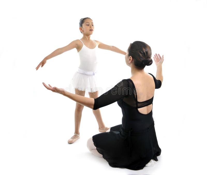 Young little girl ballerina learning dance lesson with female ballet teacher. Young little girl ballerina learning dance lesson with female ballet teacher