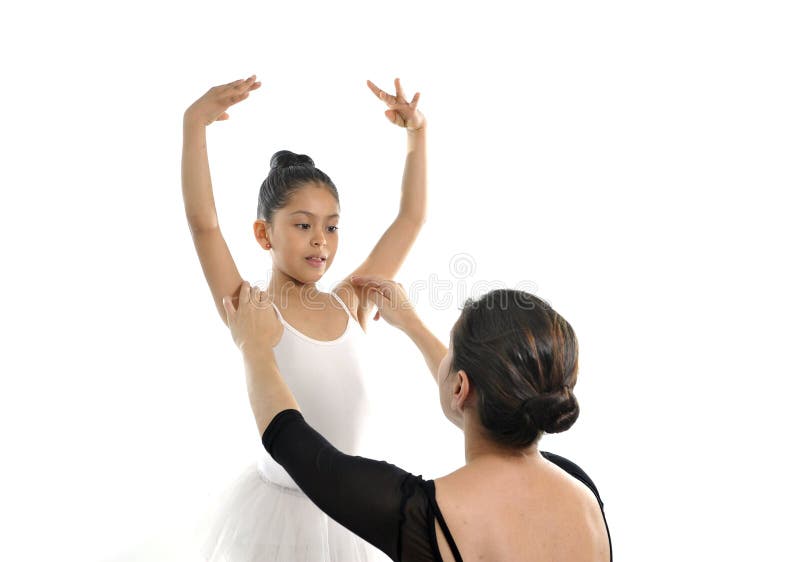 Young little girl ballerina learning dance lesson with female ballet teacher. Young little girl ballerina learning dance lesson with female ballet teacher