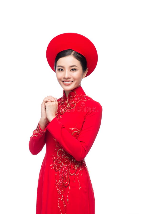 Молодая въетнамская женщина в платье Ao Dai с моля желанием жеста стоковое фото rf