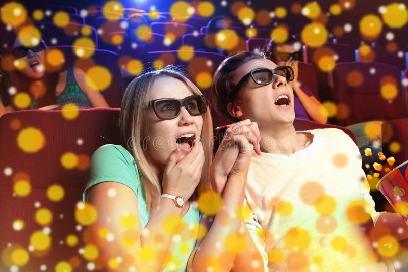 Young couple sitting at the cinema, watching a horrors film. Cinema photo series. Young couple sitting at the cinema, watching a horrors film. Cinema photo series