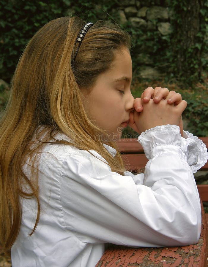 Angel (cute girl) in white dress, and closed eyes with his clasped hands folded in prayer. Vertical color photo. Angel (cute girl) in white dress, and closed eyes with his clasped hands folded in prayer. Vertical color photo.