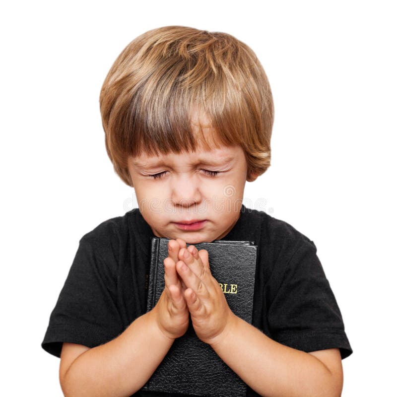 Little boy praying with the Bible in hand. Little boy praying with the Bible in hand