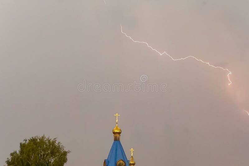 Молния во время грозы в небе над куполом и чр стоковая фотография