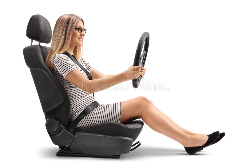 Young woman sitting in a car seat and holing a steering wheel isolated on white background. Young woman sitting in a car seat and holing a steering wheel isolated on white background