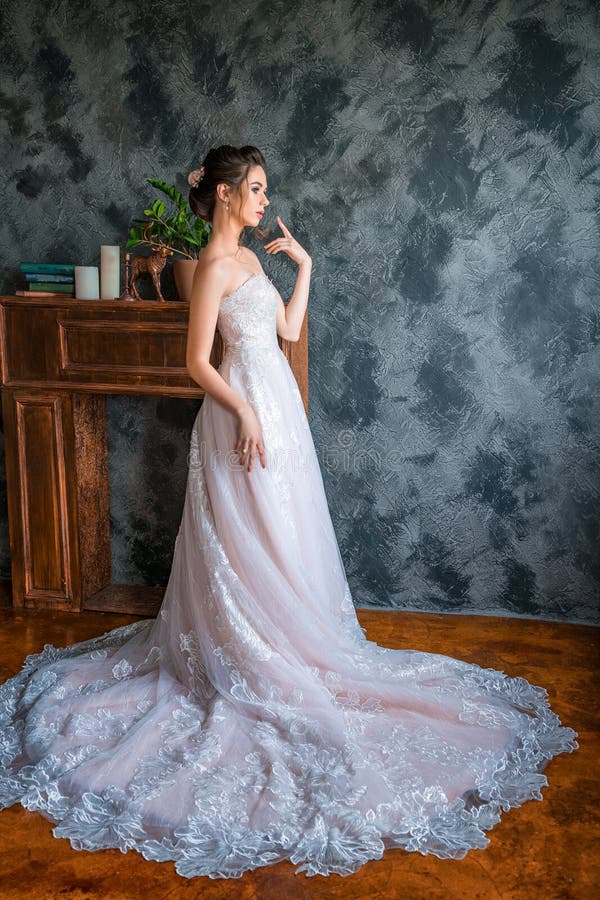 Молодая невеста в длинном платье представляя для камеры стоковые фото Молодая невеста в длинном платье представляя для камеры стоковые фото