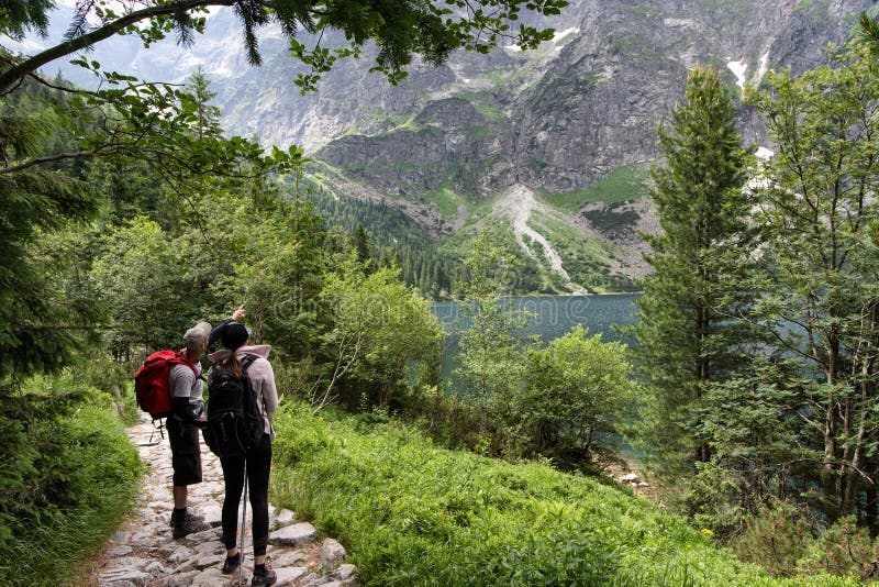 Молодой человек и дорога женщины исследуя в горе Национальный парк Tatra стоковая фотография rf Молодой человек и дорога женщины исследуя в горе Национальный парк Tatra стоковая фотография rf