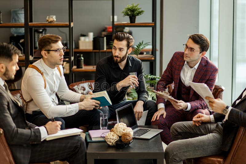 Young handsome guys in tux hold meeting in office, successful people discuss strategies, projects and ideas. business coworking in conference room. Young handsome guys in tux hold meeting in office, successful people discuss strategies, projects and ideas. business coworking in conference room