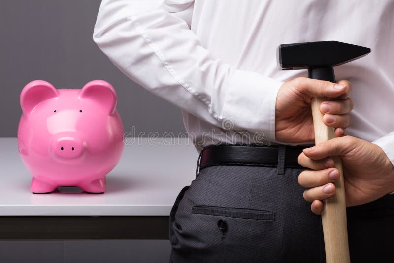 Businessman Hiding Hammer In Front Of Pink Piggy Bank. Businessman Hiding Hammer In Front Of Pink Piggy Bank