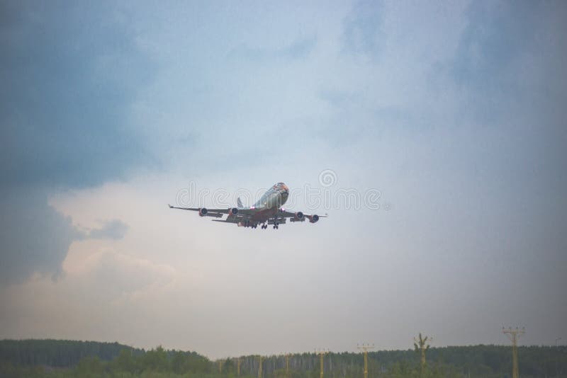 Moscow, Russia - 9 May 2019: Close-up of a passenger plane with a pattern of a tiger airline Rossiya flies on a blue sky. Moscow, Russia - 9 May 2019: Close-up of a passenger plane with a pattern of a tiger airline Rossiya flies on a blue sky