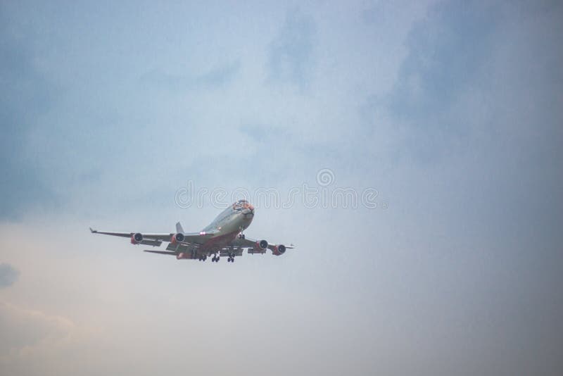 Moscow, Russia - 9 May 2019: Close-up of a passenger plane with a pattern of a tiger airline Rossiya flies on a blue sky. Moscow, Russia - 9 May 2019: Close-up of a passenger plane with a pattern of a tiger airline Rossiya flies on a blue sky