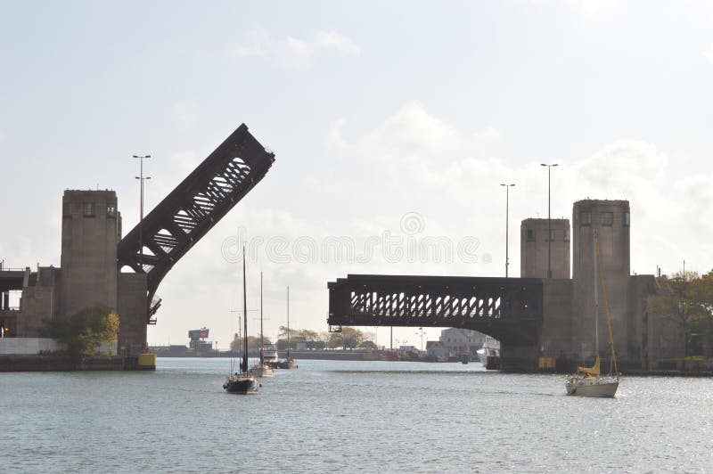 This is a picture of the Lake Shore Drive Bridge in the up position over the Chicago River with boats moving down the Chicago River. This picture was taken on October 1, 2014. This is a picture of the Lake Shore Drive Bridge in the up position over the Chicago River with boats moving down the Chicago River. This picture was taken on October 1, 2014.