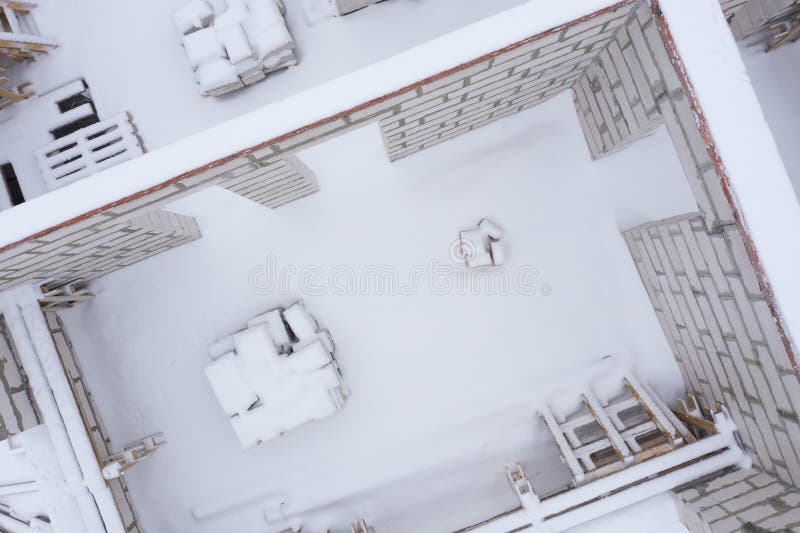 Above view of unfinished house walls without roof in winter. Above view of unfinished house walls without roof in winter