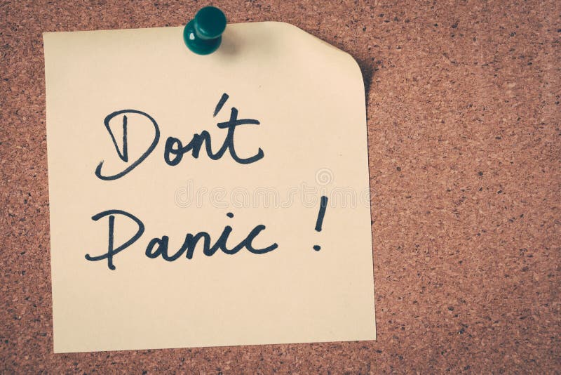 Don't Panic note pin on bulletin board. Don't Panic note pin on bulletin board