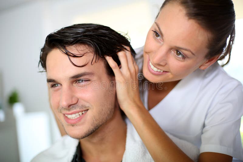 Hairdresser doing head massage to customer. Hairdresser doing head massage to customer