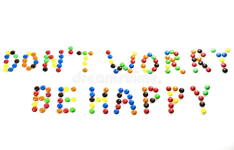 The phrase 'Don't worry, be happy' written with sugar-coated candy. The phrase 'Don't worry, be happy' written with sugar-coated candy