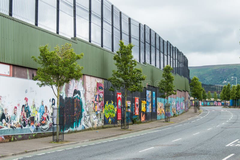 Political mural in Belfast, Northern Ireland. Falls Road and Shankill Road are famous for their political murals.This wall divide the part catholic and that protestant. Political mural in Belfast, Northern Ireland. Falls Road and Shankill Road are famous for their political murals.This wall divide the part catholic and that protestant