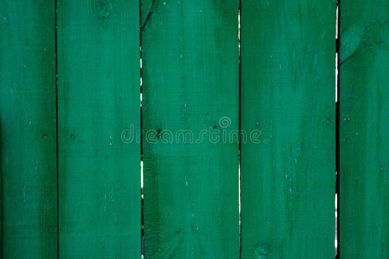 Saturated dark green wooden planking background with cracks and splits on it surface. Saturated dark green wooden planking background with cracks and splits on it surface