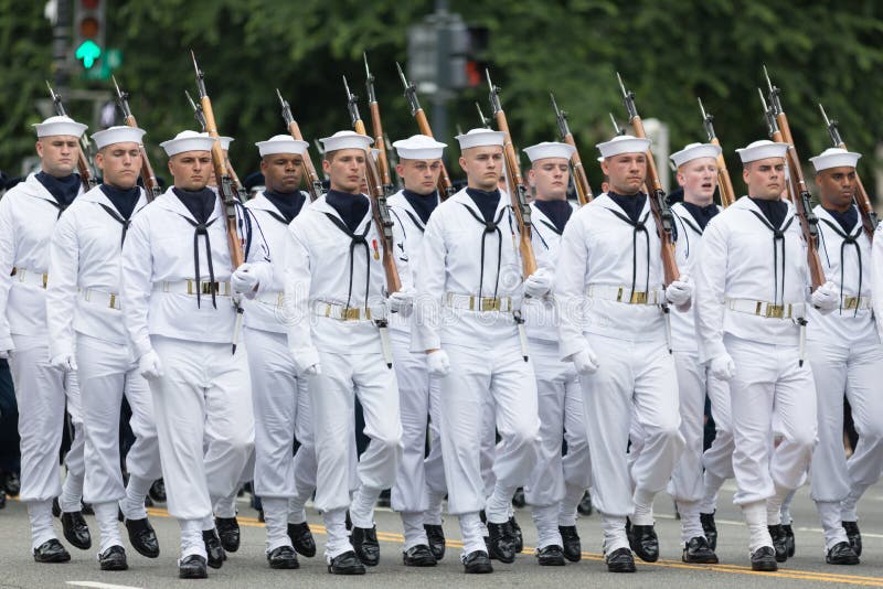 Washington, D.C., USA - May 28, 2018: The National Memorial Day Parade, Member of the United States Navy, with rifles, marching down Constitution Avenue. Washington, D.C., USA - May 28, 2018: The National Memorial Day Parade, Member of the United States Navy, with rifles, marching down Constitution Avenue