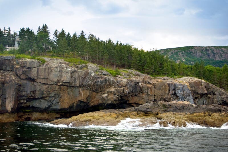 A view from the water of Acadia National Park in Bar Harbor, Maine. Includes water, forest, mountain, and sky. A view from the water of Acadia National Park in Bar Harbor, Maine. Includes water, forest, mountain, and sky.