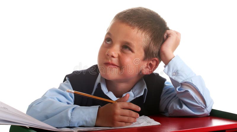 Young boy in elementary/primary school uniform working. Isolated. Copyspace. Young boy in elementary/primary school uniform working. Isolated. Copyspace