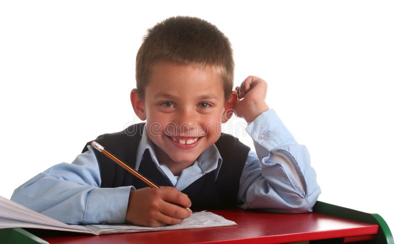 Young boy in elementary/primary school uniform working. Young boy in elementary/primary school uniform working