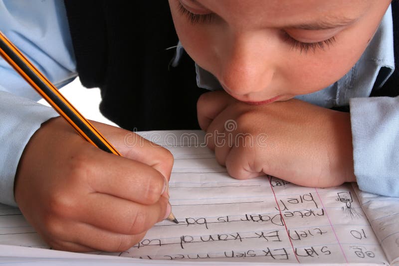 Young boy in elementary/primary school uniform working. Isolated. Copyspace. Young boy in elementary/primary school uniform working. Isolated. Copyspace