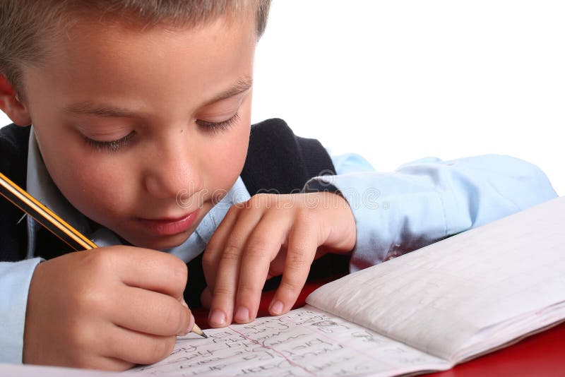 Young boy in elementary/primary school uniform working. Isolated. Copyspace. Young boy in elementary/primary school uniform working. Isolated. Copyspace