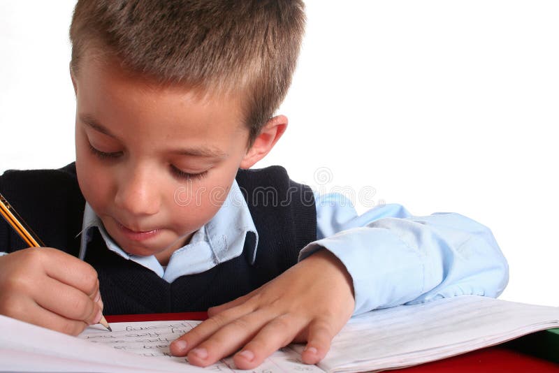 Young boy in elementary/primary school uniform working. Isolated. Copyspace. Young boy in elementary/primary school uniform working. Isolated. Copyspace