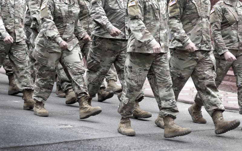 US soldiers. US army. Military forces of the United States of America.   Soldiers marching on the parade. Veterans Day. Memorial Day. US soldiers. US army. Military forces of the United States of America.   Soldiers marching on the parade. Veterans Day. Memorial Day.