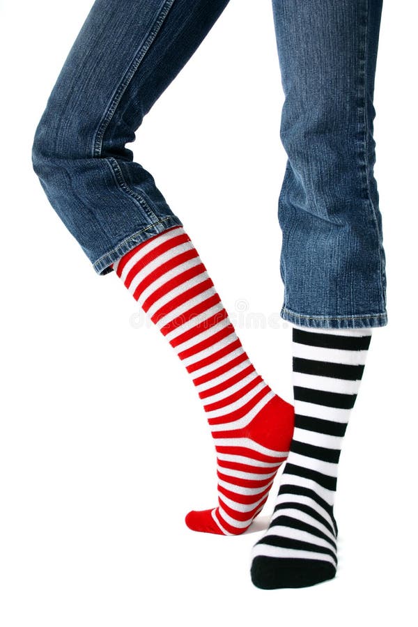 Mismatched striped socks isolated against a white backdrop. Mismatched striped socks isolated against a white backdrop.